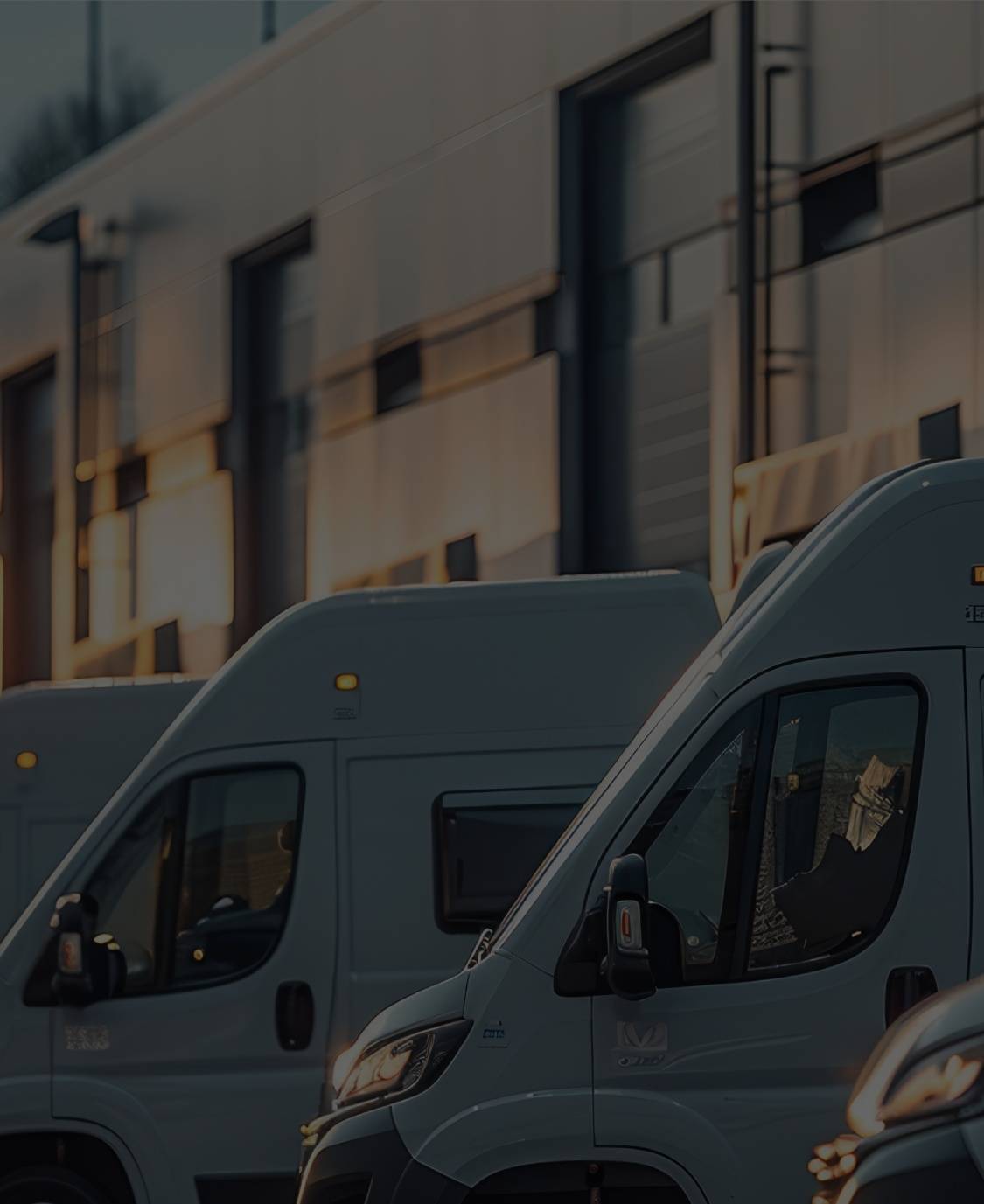 A fleet of vans in a parking lot
