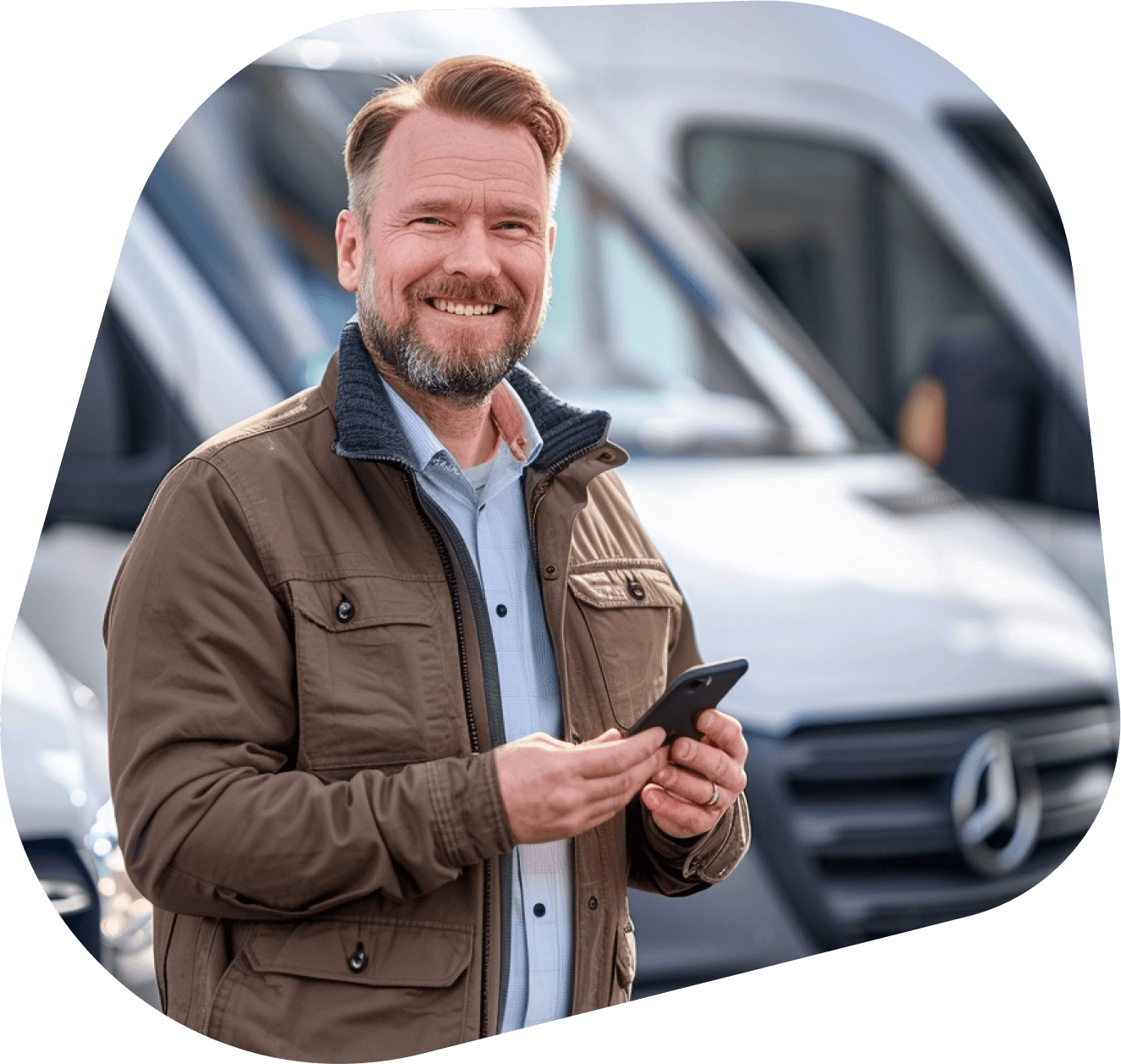 A fleet manager holding a phone